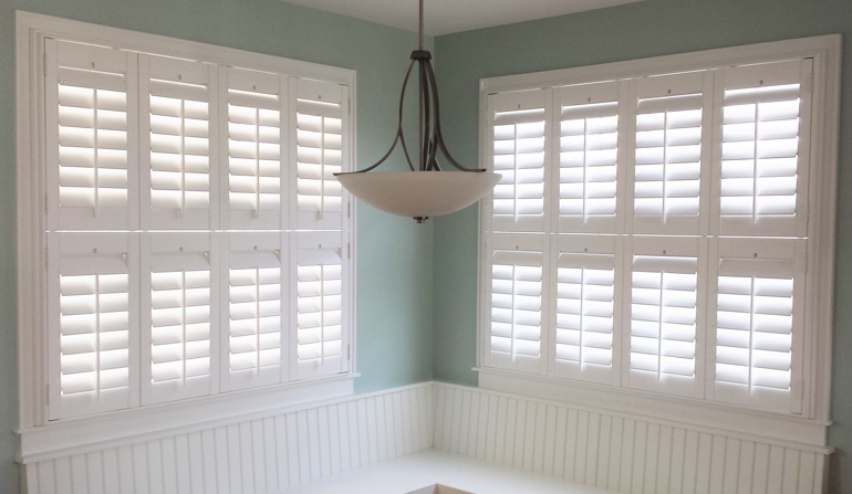 Pastel green wall in Cincinnati kitchen with shutters.